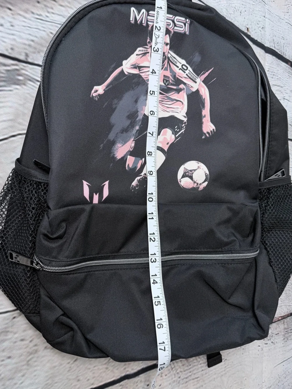 Black Messi backpack with graphic of a soccer player in action